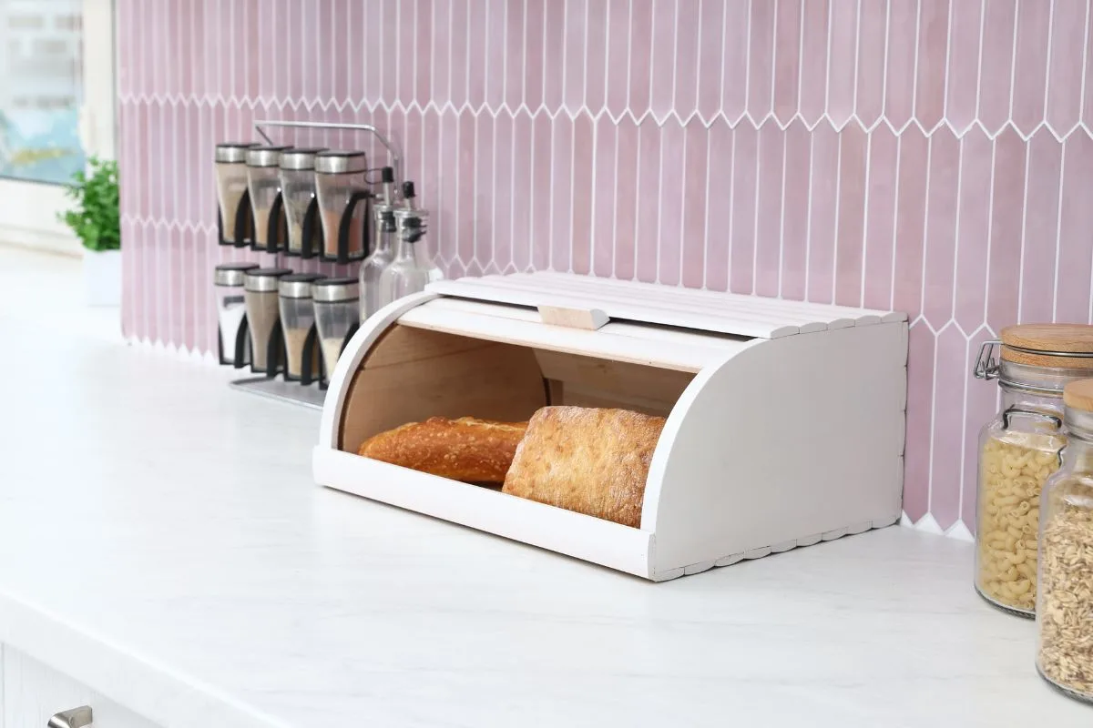 bread stored in a bread box on the counter instead of the refrigerator